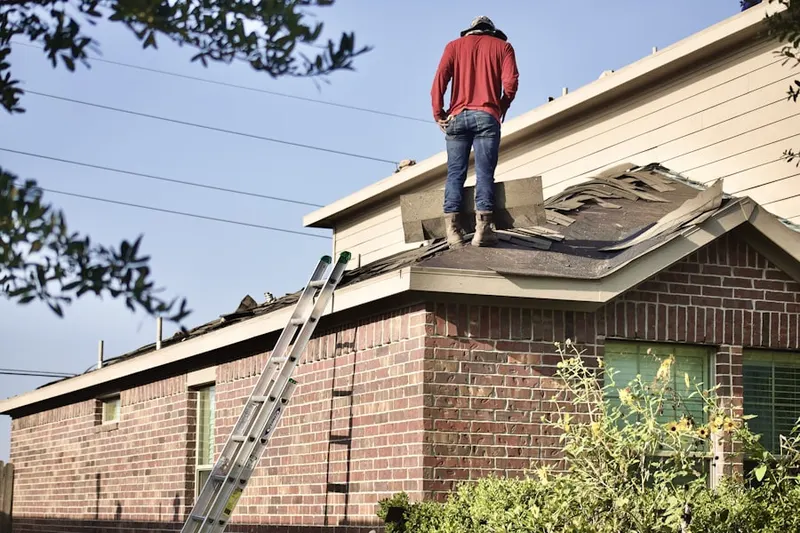 Professional roofer working on a residential roof in Misty Oaks